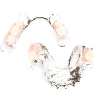 Two partial dentures with metal attachments against white background