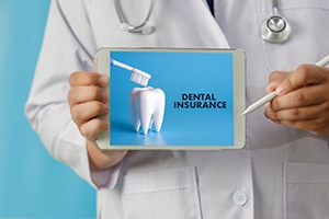Medical professional holding iPad displaying dental insurance info