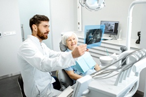 Dentist and patient discussing candidacy for full mouth reconstruction
