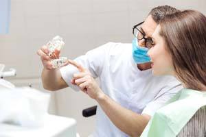 Dentist and patient discussing cost of dental implants in Watertown