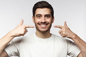 Smiling man, enjoying the money-saving benefits of dental implants