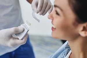 Dentist giving dental patient a brief description of Invisalign® treatment
