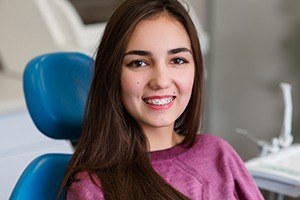 Woman with traditional braces in dental chair