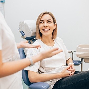 Woman smiling at dentist during preventive dentistry visit