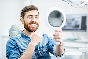 Man looking at smile after dental checkup and teeth cleaning visit