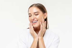 Smiling woman in white blouse with perfect teeth