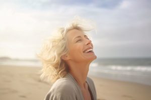 Woman with beautiful teeth, smiling on beach