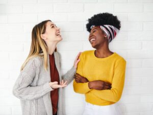 Two female friends engaged in happy conversation